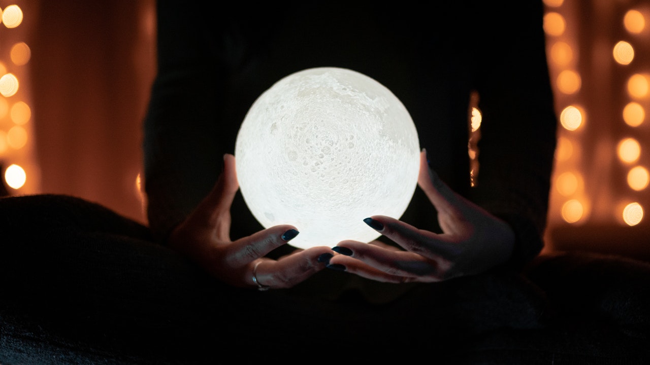 A picture of a person holding a crystal ball.